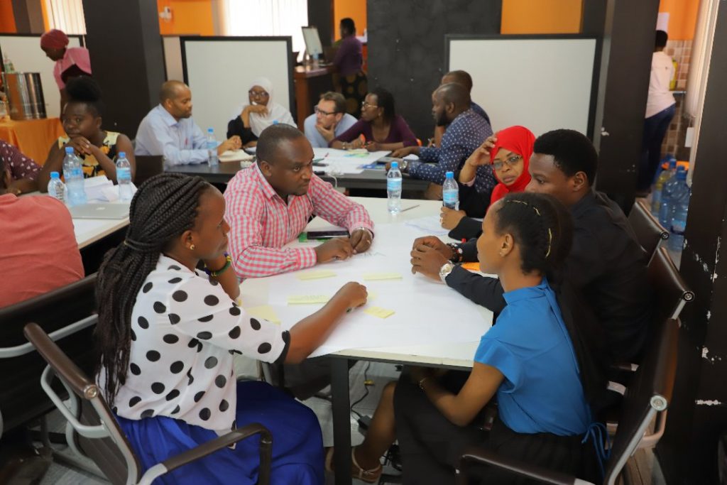 Tanzanians having a discussion around a table.