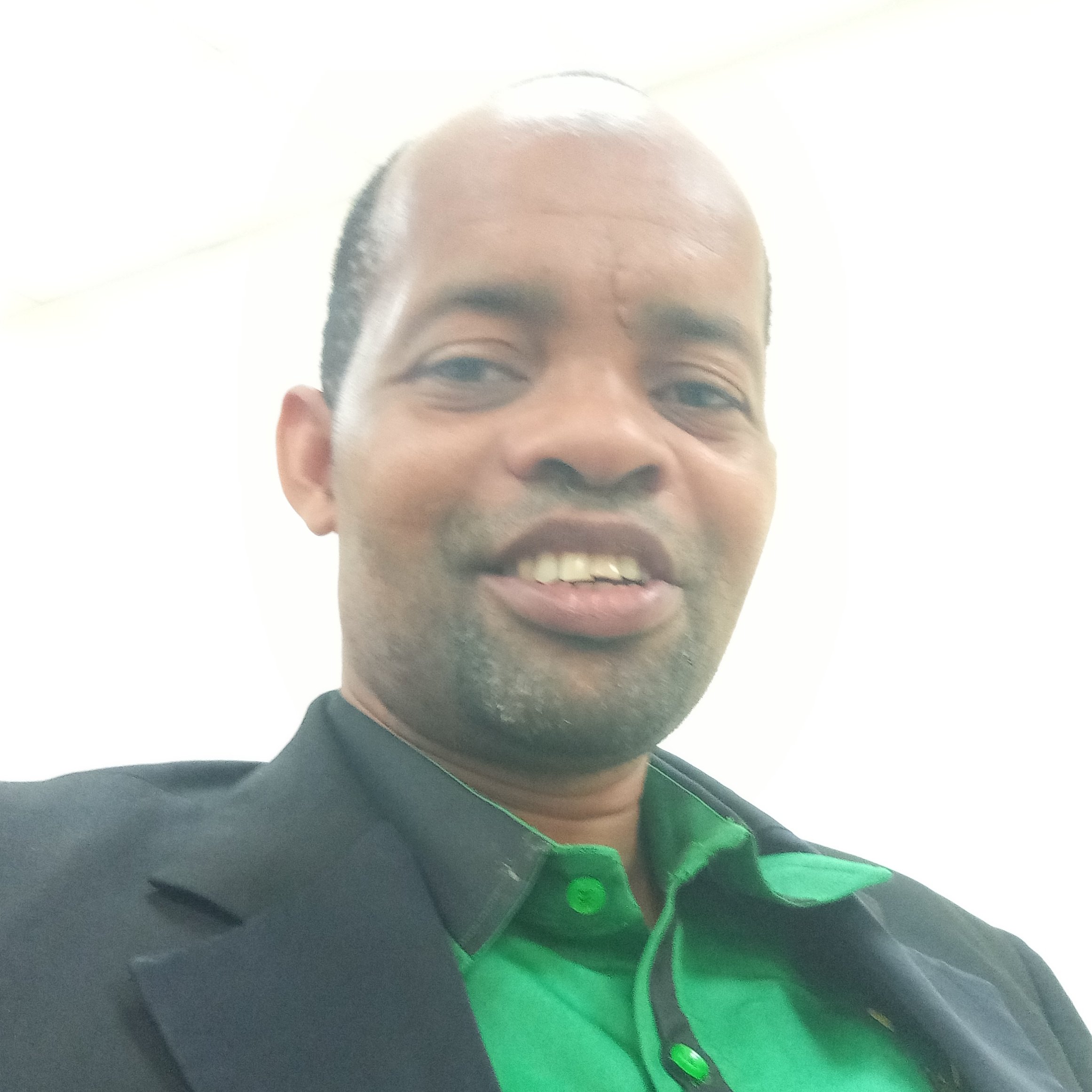  A Tanzanian man wearing a green shrit.
