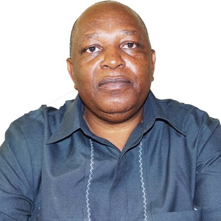 A Tanzanian man wearing a dark blue shirt.