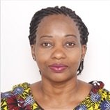 A Tanzanian woman in a colourful shirt.and Resilience Academy experts when meeting the VC of Ardhi University