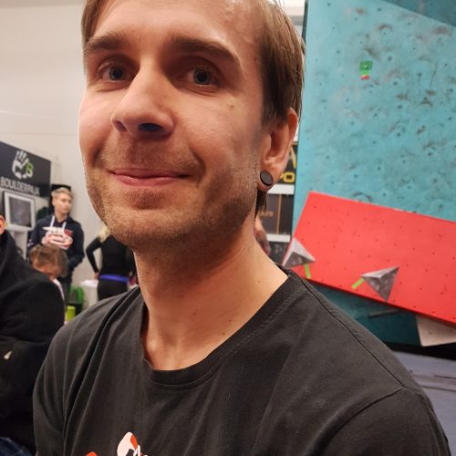 A finish man in a climbing gym
