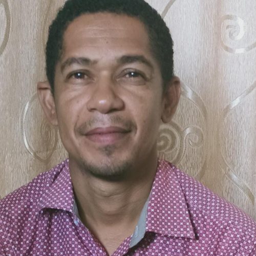 Image of a Tanzanian man with a purple shirt.