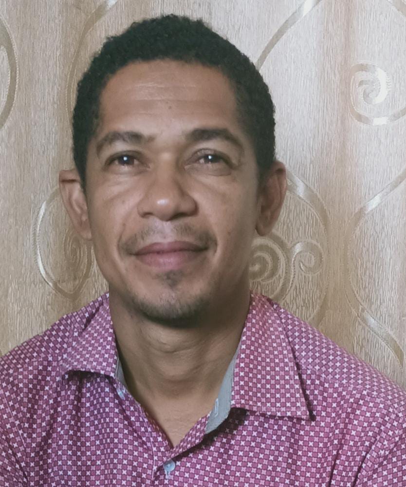 Image of a Tanzanian man with a purple shirt.