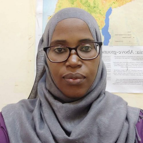 Tanzanian woman with glasses and a map on the background